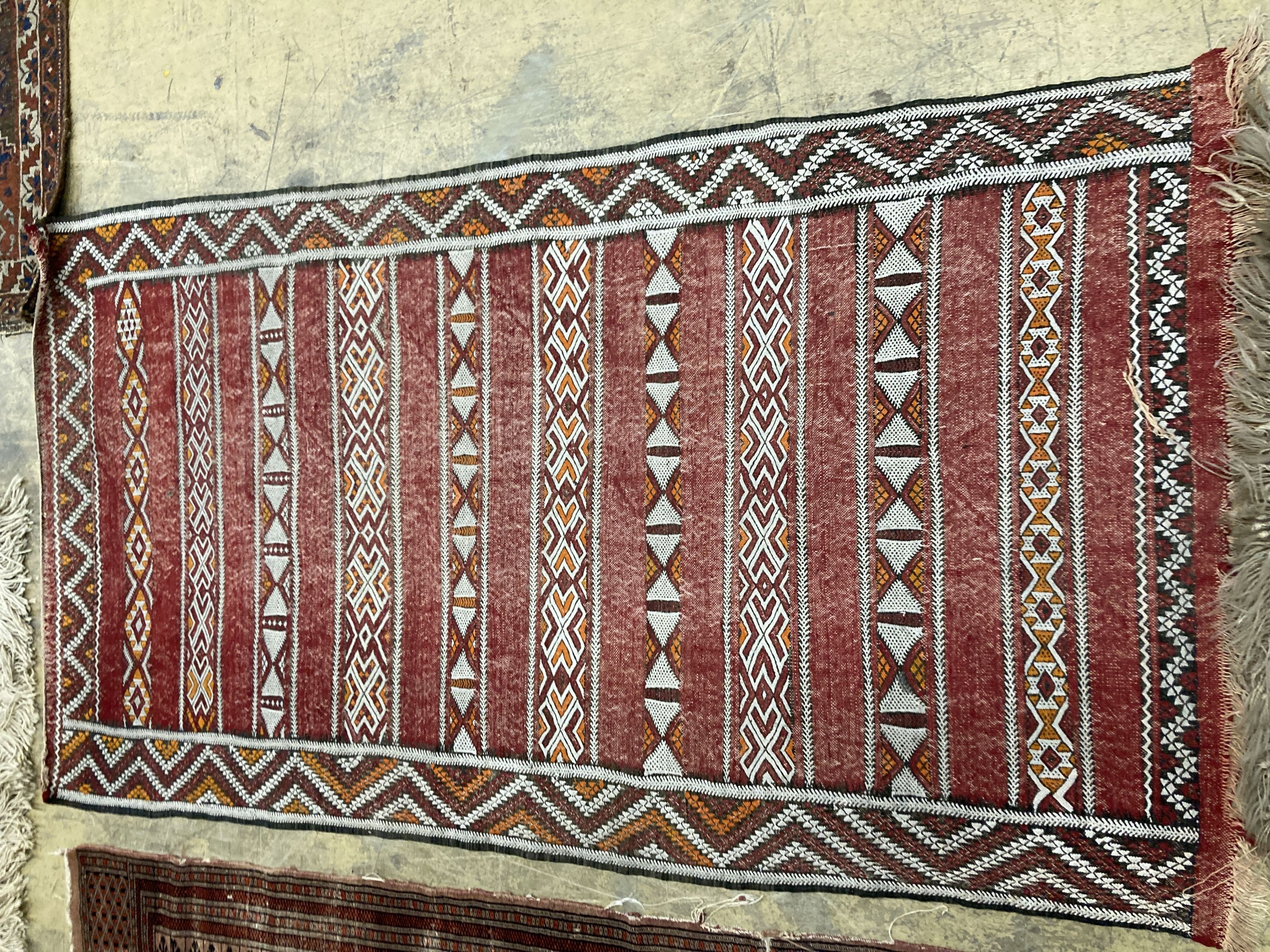 A Bokhara orange ground rug 198 x 125 cms, a smaller Anatolian flat weave rug and Bokhara prayer mat.